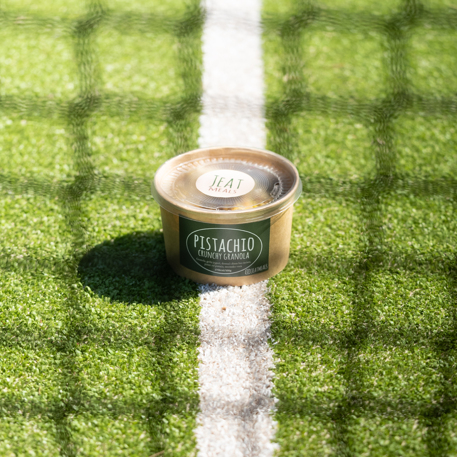 Pistachio crunchy granola on tennis court